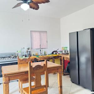 a kitchen with a table and a stainless steel refrigerator at Casa el palmar in Guaymas