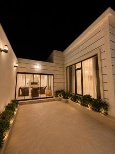 a house with a large patio at night at White Dream Villa in Mərdəkan