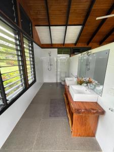 a bathroom with two sinks and a mirror at Ucuilagi Resort in Matei +33 photos