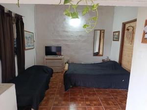 a bedroom with a bed and a tv in it at La esquina in Olavarría