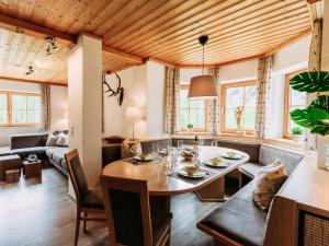 ein Esszimmer und ein Wohnzimmer mit Holzdecke in der Unterkunft Barney M in Rauris