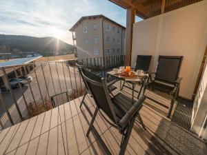 a balcony with a table and chairs on a building at Mariazeller Zirbennest in Mariazell