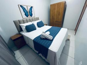 a bed with a pair of shoes sitting on it at Aconchego e praticidade in Mineiros