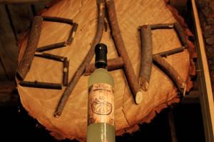 a bottle of wine sitting on top of a wooden table at Yanamanka in Yanama