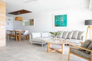 a living room with a couch and a table at Noosa Crest Resort in Noosa Heads