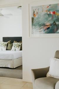 a living room with a bed and a couch at Noosa Crest Resort in Noosa Heads