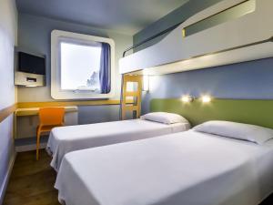 a room with two beds and a window at ibis budget Sertaozinho in Sertãozinho +57 photos
