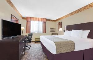 a hotel room with a large bed and a flat screen tv at FairBridge Inn Express Bellingham in Bellingham +3 photos