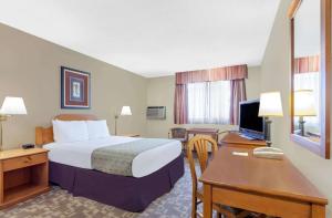 a hotel room with a bed and a desk at FairBridge Inn Express Bellingham in Bellingham