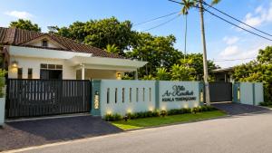 a house with a gate in front of it at Villa Ar Raudhah Kuala Terengganu in Kampong Cherong Baru