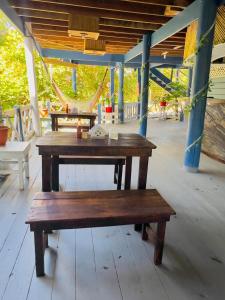 a wooden table and bench on a patio at LOTO'S House in West End