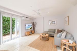 a living room with a couch and a table at Sandcastles 1, 8 Ala Moana Way - air conditioned townhouse with Wi-Fi and Complex Pool in Fingal Bay