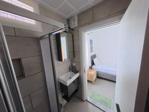 a small bathroom with a sink and a bed at Merhaba Pansiyon in Bodrum City +57 photos