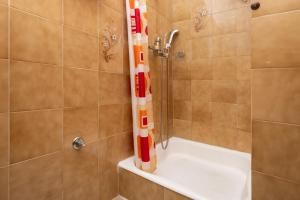 a bathroom with a shower with a white tub at Apartments Vedra in Baška Voda +44 photos