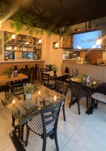 a restaurant with tables and chairs and a screen at CASA LAURA hotel & suites in Cuenca