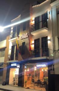 a building with a restaurant in front of it at night at CASA LAURA hotel & suites in Cuenca +2 photos