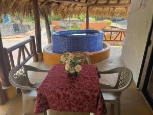 a table and chairs on a balcony with a fountain at Villas Mercedes in Zihuatanejo