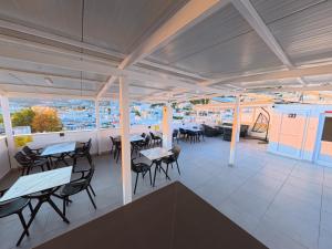 a restaurant with tables and chairs and a view of a city at Merhaba Pansiyon in Bodrum City