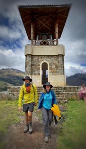 two people walking in front of a windmill at Yanamanka in Yanama