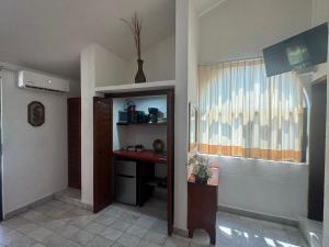 a room with a hallway with a desk and a window at Villas Mercedes in Zihuatanejo