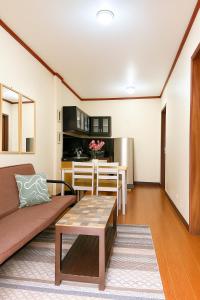 a living room with a couch and a table at Audi's Serviced Apartment in Puerto Princesa City