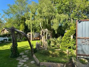a garden with a wooden arch in the grass at Stay and Spa in Sooke