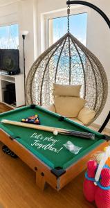 a ping pong table with a hammock over it at AB Preveza Apartments-15 Meters Over the Sea Attic & Alexander's the Great Executive Suite in Preveza +124 photos