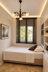 a bedroom with a large white bed and a window at Villa Jasmine in Kartepe +27 photos