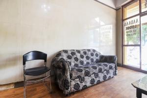 a living room with a couch and a chair at Hotel O Aadaab in Hyderabad