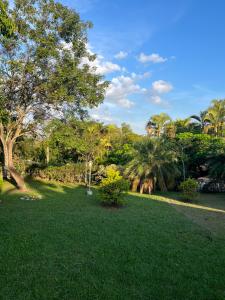 a park with green grass and trees and a field at Quarto triplo - Casa Azul - Águas de São Pedro in Águas de São Pedro