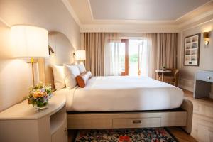 a hotel room with a large bed and a table at Delamar Greenwich Harbor in Greenwich +22 photos