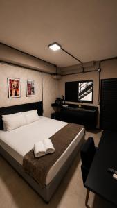 a bedroom with a bed with two towels on it at ADD Hóteis Congonhas in São Paulo