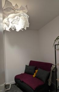 a room with a couch with a pile of sheets at Cosy Centre in Dundee +8 photos
