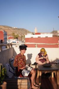 two women sitting on a ledge with a table at Grip Sea Morocco in Agadir