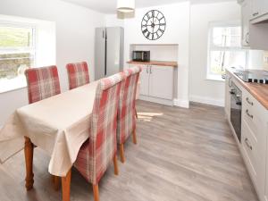 a kitchen with a table and four chairs at High Park House in Brough