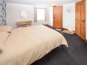 a bedroom with a large bed and a window at High Park House in Brough +10 photos