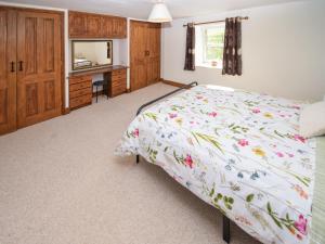 a bedroom with a bed and a desk and a mirror at High Park House in Brough