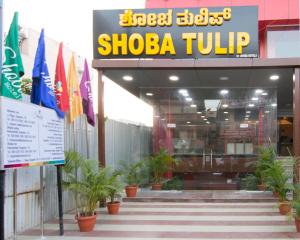 a shop with flags in front of a building at Shoba Tulip Hebbal in Bangalore