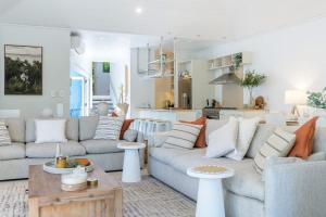 a living room with a couch and a table at Villa 8 on Murphy Prime Location & Lifestyle in Port Douglas