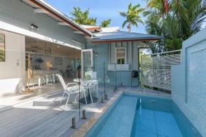 a house with a swimming pool and a patio at Villa 8 on Murphy Prime Location & Lifestyle in Port Douglas +11 photos