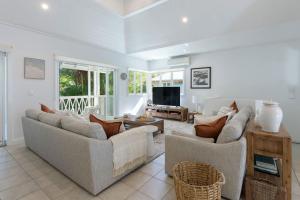 a living room with two couches and a tv at Villa 8 on Murphy Prime Location & Lifestyle in Port Douglas