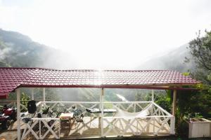 a pavilion with a view of a mountain at villa los recuerdos in Jarabacoa
