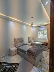 a bedroom with two beds and a window at House apartment in Tangier