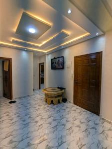 a room with a stone floor and a wooden door at House apartment in Tangier +4 photos