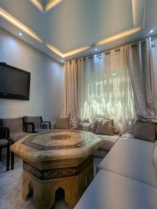 a living room with a table and a couch at House apartment in Tangier