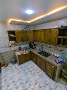 a kitchen with wooden cabinets and a counter top at House apartment in Tangier
