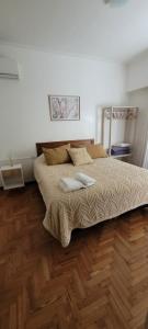 a bedroom with a bed with two pillows on it at Departamento luminoso con balcón in La Plata