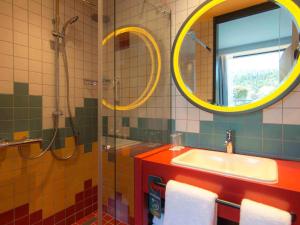a bathroom with a sink and a shower and a mirror at ibis Styles Tbilisi Center in Tbilisi City +144 photos