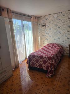 a bedroom with a bed and a large window at Cabaña Tongariki in Hanga Roa