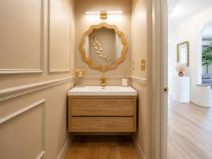 a bathroom with a sink and a mirror on the wall at Coastal Chateau Cottages in Ocean City